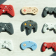 A photo of nine different models of BabyGlitch controllers in various colors.